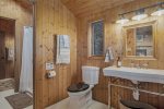Upper level bathroom has two separate toilet vanity areas with a shared shower between